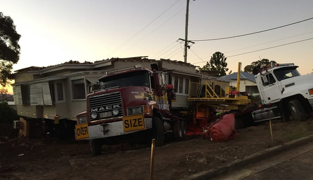 House cut in two and loaded on removal truck
